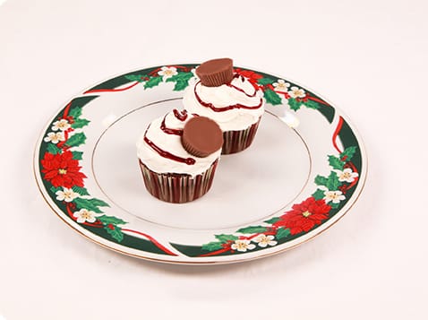2 Candy Cane Swirl Cupcakes on a holiday plate